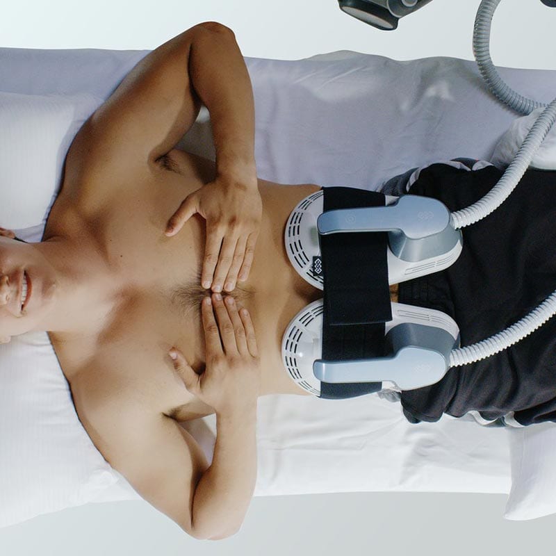 Male patient receiving emsculpt treatment
